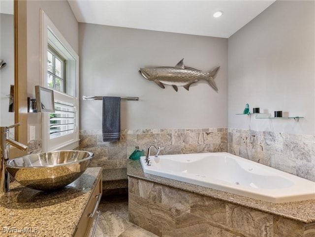 bathroom featuring a jetted tub and vanity