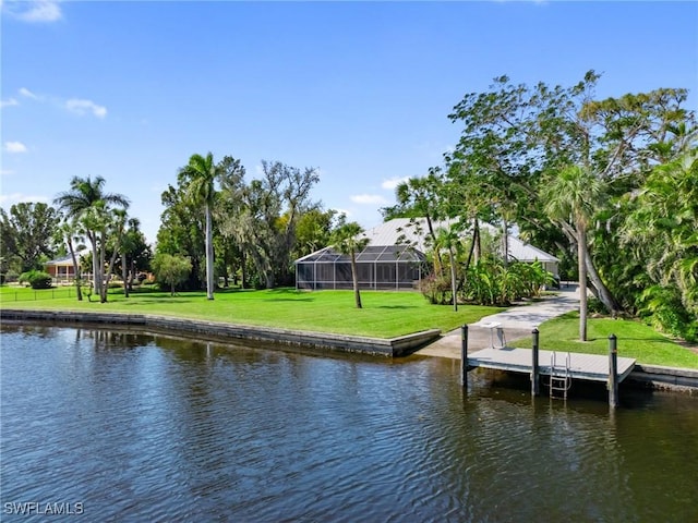 view of dock with a yard and a water view