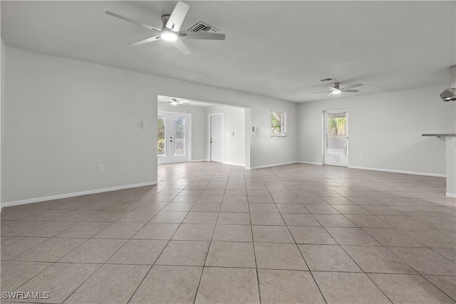 unfurnished living room with french doors, light tile patterned flooring, plenty of natural light, and a ceiling fan