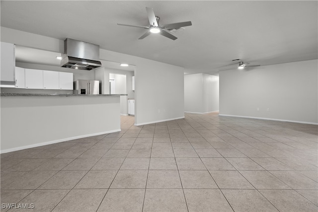 unfurnished living room with ceiling fan, visible vents, baseboards, and light tile patterned flooring