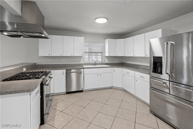 kitchen with light tile patterned floors, dark countertops, stainless steel appliances, ventilation hood, and a sink