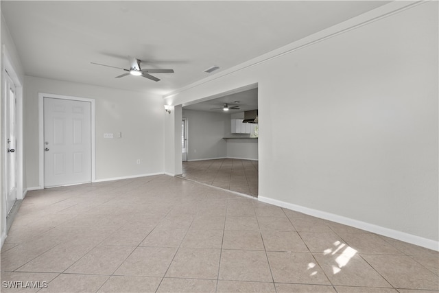 unfurnished living room featuring a ceiling fan, visible vents, baseboards, and light tile patterned floors