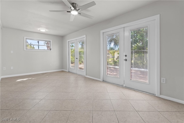 doorway with french doors, ceiling fan, baseboards, and light tile patterned floors