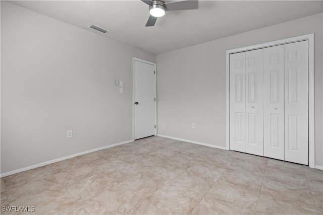 unfurnished bedroom with a closet, visible vents, ceiling fan, and baseboards