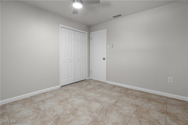 unfurnished bedroom with a ceiling fan, a closet, visible vents, and baseboards