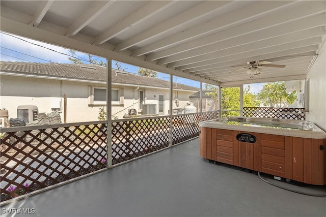 view of patio / terrace featuring a ceiling fan and a hot tub