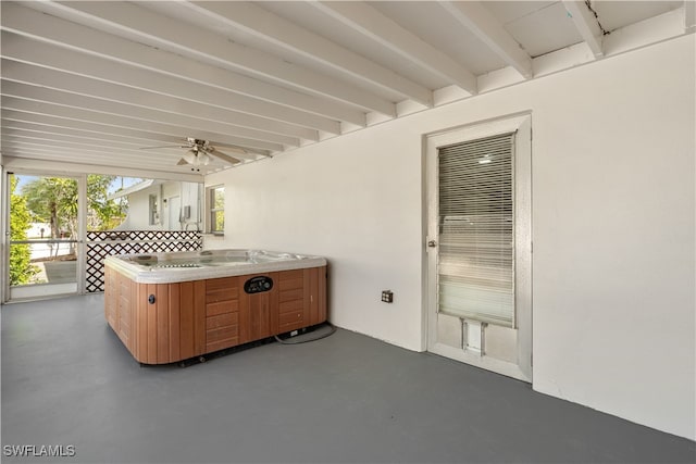 view of patio with a ceiling fan and an indoor hot tub