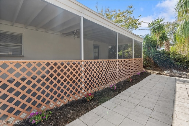 view of property exterior featuring a sunroom