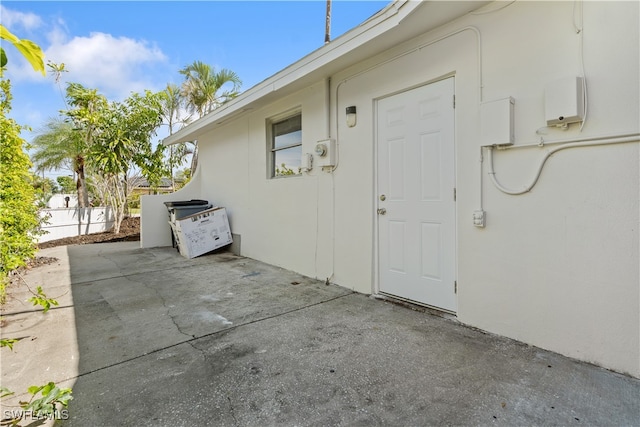 property entrance with a patio area and fence