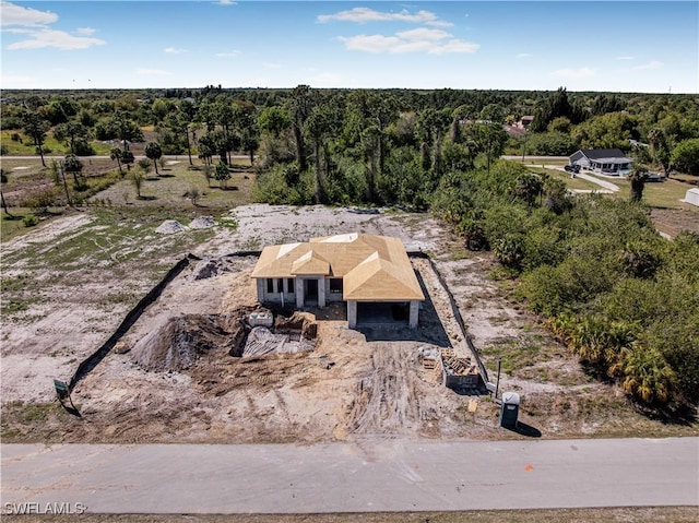 birds eye view of property featuring a view of trees