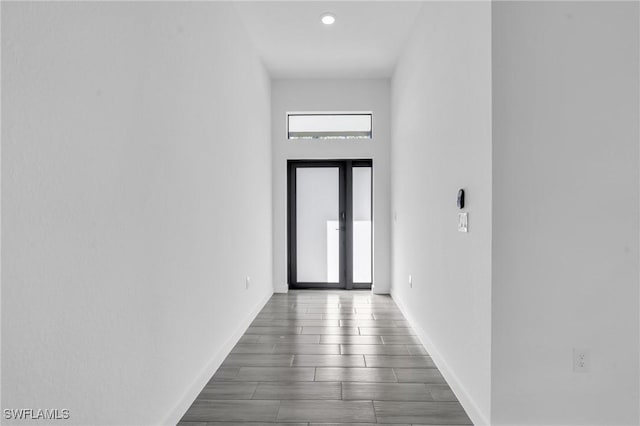 doorway to outside featuring baseboards