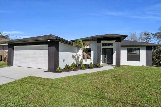 prairie-style house with a garage, driveway, a front lawn, and stucco siding