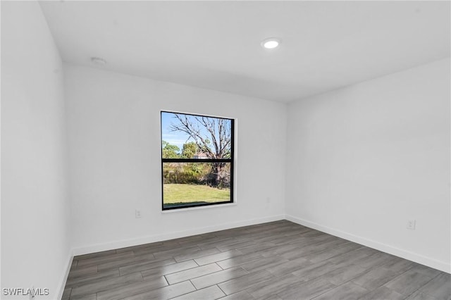 empty room featuring baseboards and wood finished floors