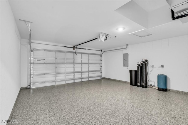 garage with a garage door opener, electric panel, and baseboards