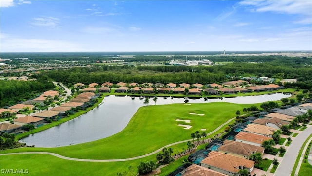 drone / aerial view with a water view and golf course view