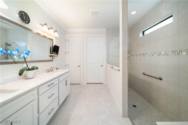 bathroom with crown molding, double vanity, a sink, baseboards, and walk in shower