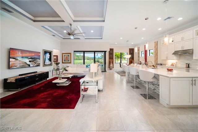 living room with ornamental molding, visible vents, and coffered ceiling