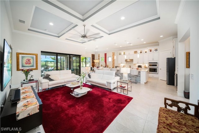 living area with ceiling fan, visible vents, coffered ceiling, and crown molding