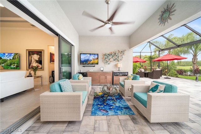 living room featuring ceiling fan and a sunroom