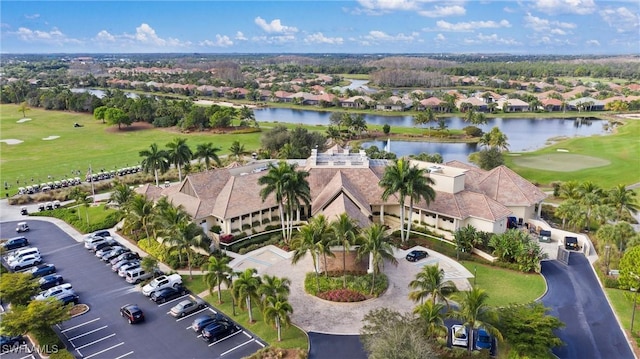 aerial view featuring view of golf course, a water view, and a residential view