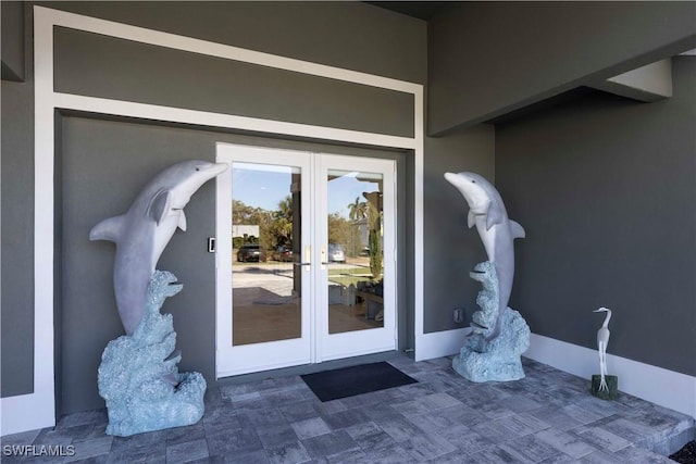 entrance to property with french doors and stucco siding