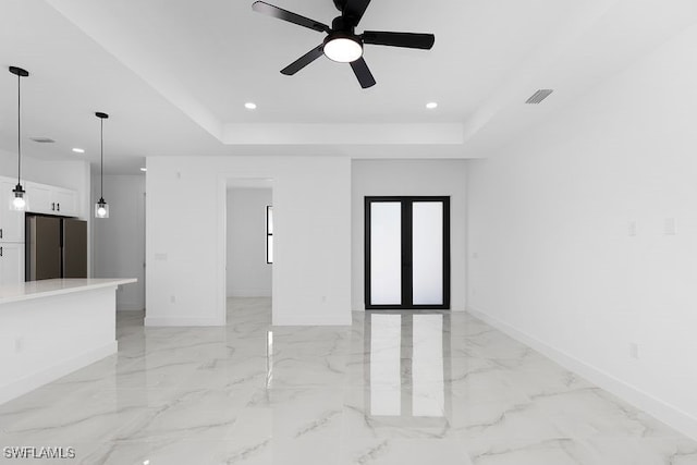 unfurnished room featuring marble finish floor, visible vents, a raised ceiling, and recessed lighting