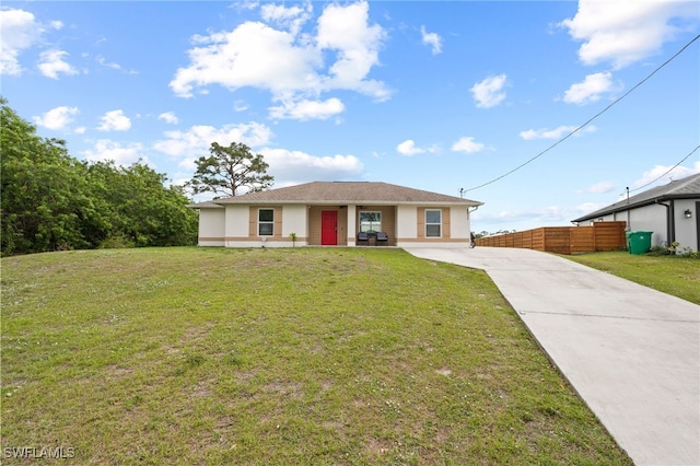 5011 Dania Cir, Labelle, FL 33935 - view of front of property with stucco siding, fence, concrete driveway, and a front yard