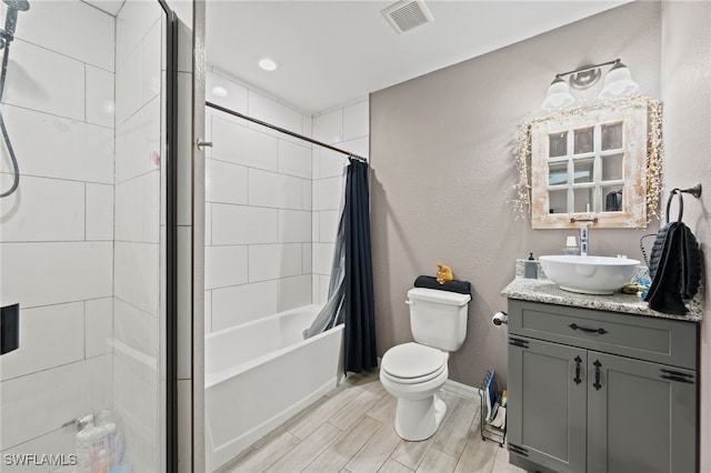5011 Dania Cir, Labelle, FL 33935 - bathroom with toilet, wood finish floors, vanity, visible vents, and baseboards