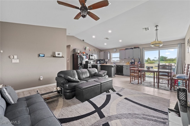 5011 Dania Cir, Labelle, FL 33935 - living room featuring lofted ceiling, light wood finished floors, baseboards, and visible vents