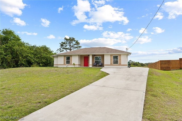 ranch-style home with concrete driveway, a front lawn, fence, and stucco siding