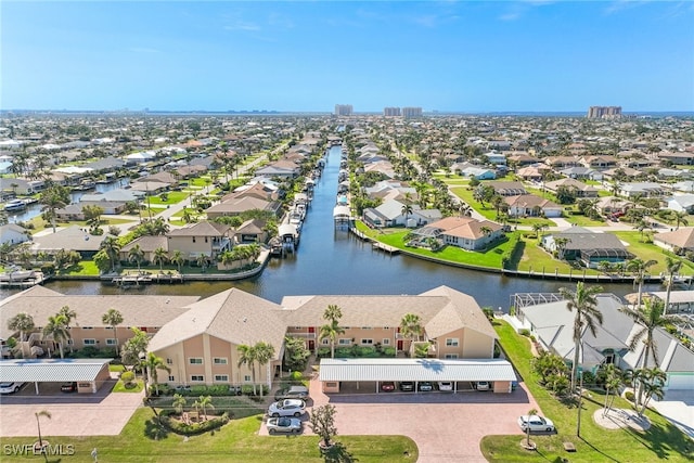 drone / aerial view featuring a water view and a residential view