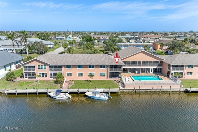 birds eye view of property with a water view and a residential view