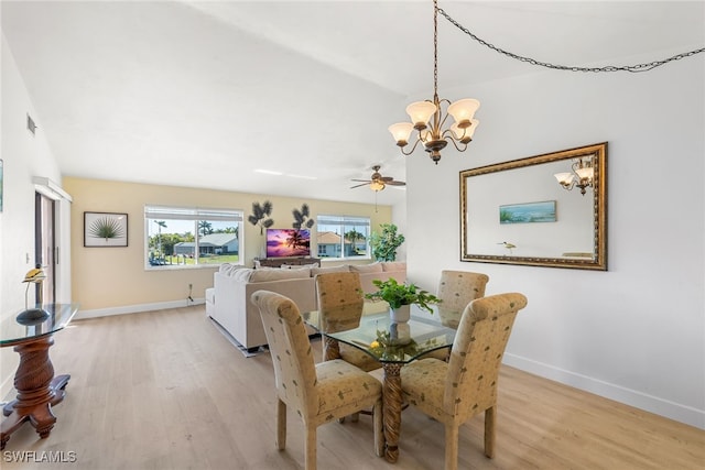 dining room with light wood finished floors, visible vents, baseboards, and a notable chandelier