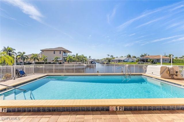 community pool with fence and a residential view