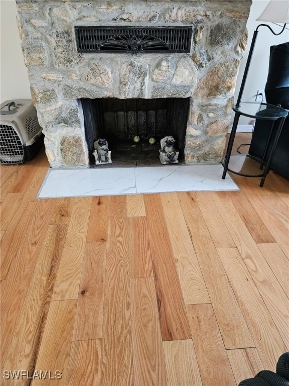 interior details with a fireplace and wood finished floors