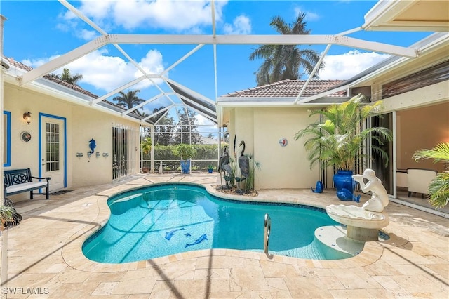 outdoor pool featuring a lanai and a patio area
