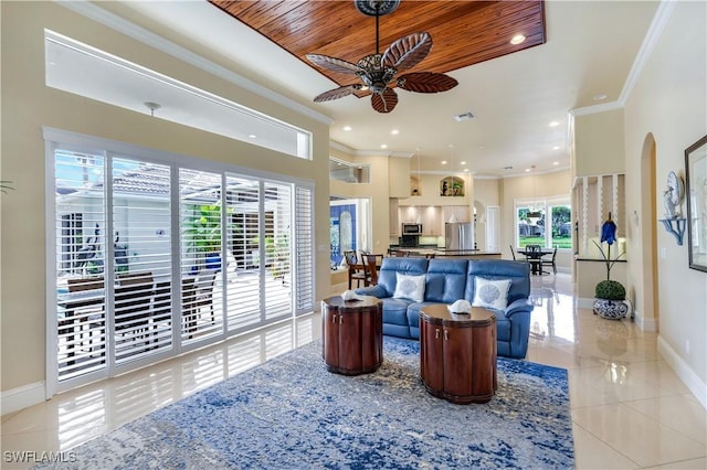 living area with baseboards, wood ceiling, ceiling fan, crown molding, and light tile patterned flooring