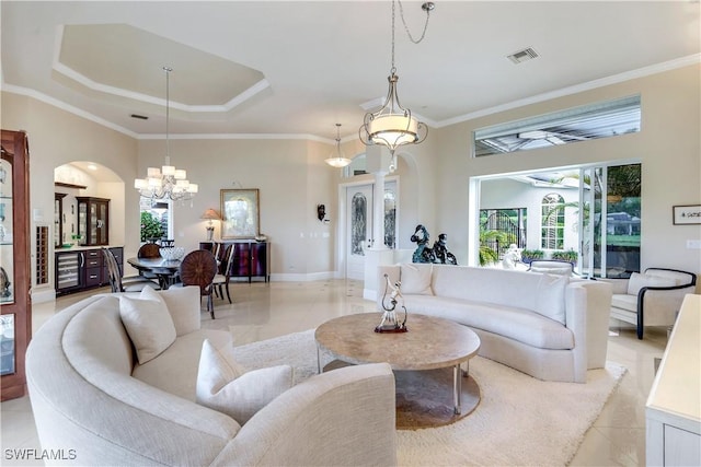 living room with light tile patterned flooring, a notable chandelier, a raised ceiling, arched walkways, and visible vents