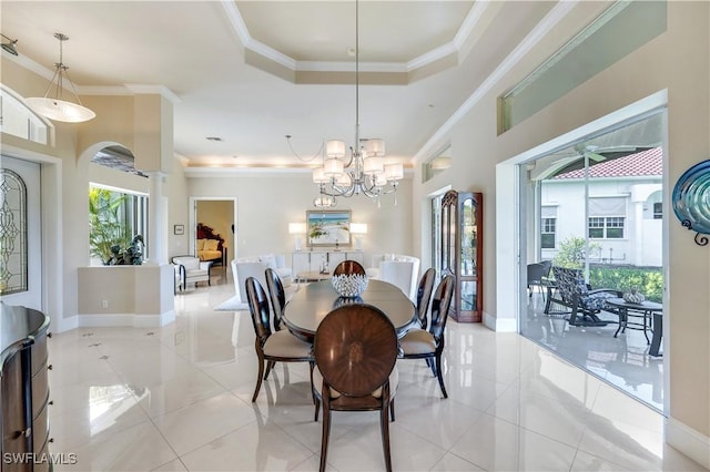 dining room featuring decorative columns, baseboards, a tray ceiling, crown molding, and light tile patterned flooring