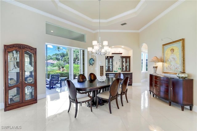 dining space featuring ornamental molding, a chandelier, a raised ceiling, and light tile patterned floors