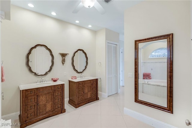 hall with baseboards, light tile patterned flooring, a sink, and recessed lighting