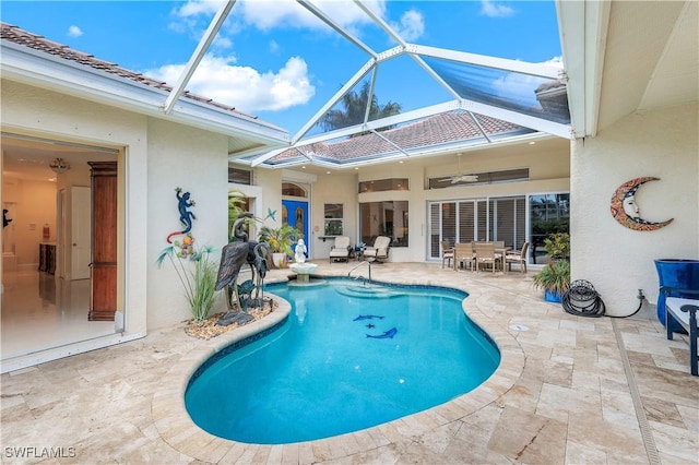 pool with glass enclosure, a ceiling fan, outdoor dining area, and a patio area