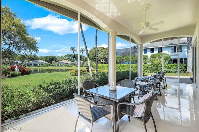 914 Spanish Moss Trl, Naples, FL 34108 - sunroom with a ceiling fan, tile patterned floors, a water view, and outdoor dining area