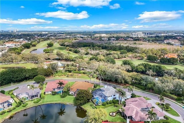 drone / aerial view with view of golf course and a water view