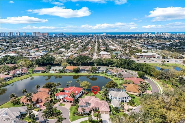 drone / aerial view featuring a residential view and a water view