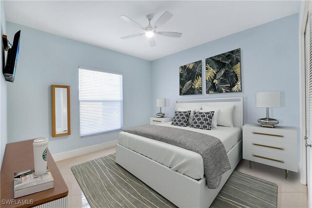 bedroom featuring a ceiling fan, light tile patterned flooring, and baseboards