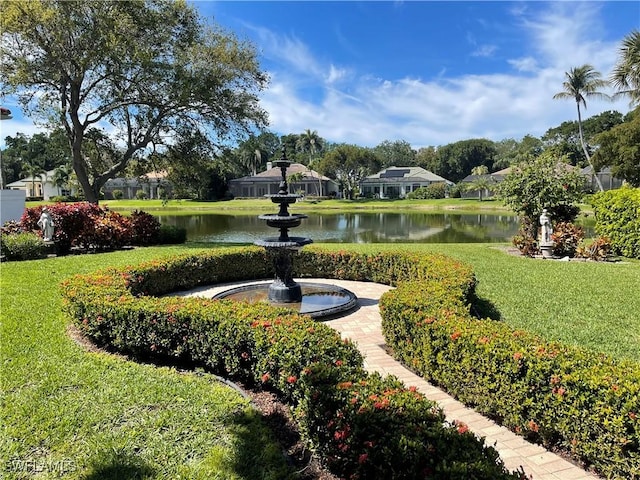 view of community featuring a yard and a water view