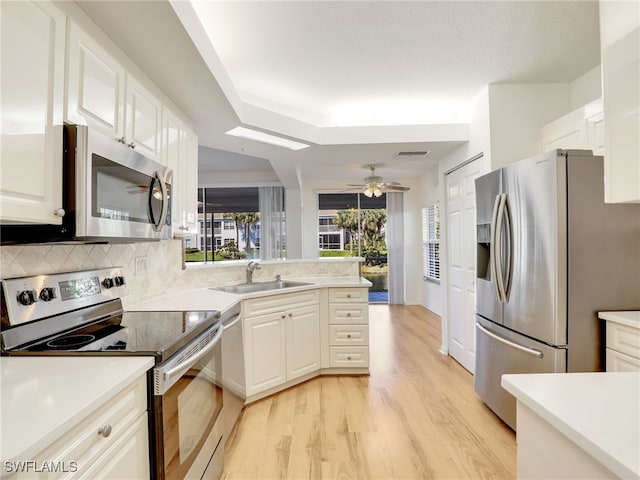 kitchen featuring light countertops, visible vents, backsplash, appliances with stainless steel finishes, and a sink