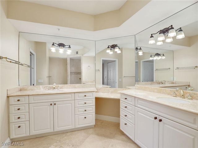 bathroom featuring two vanities, a sink, and tile patterned floors