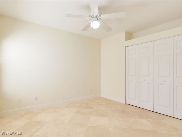 unfurnished bedroom with ceiling fan, baseboards, and a closet